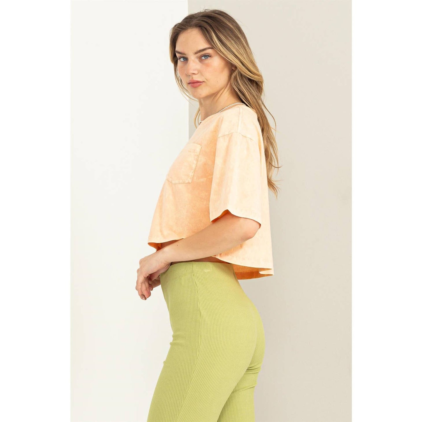 HYFVE Casual Days cropped T-shirt, soft fabric, relaxed fit, light color, displayed on a hanger with a simple background.
