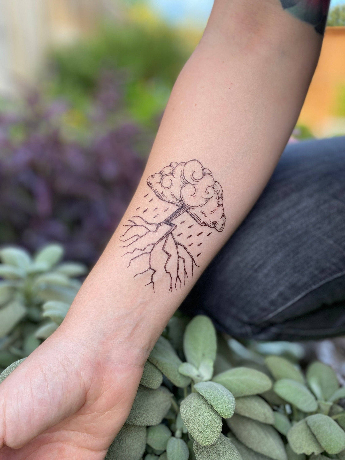 Storm Cloud temporary tattoo by NatureTats, featuring a detailed gray storm cloud design on clear skin.